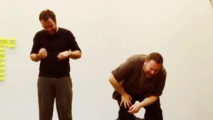 two men in rehearsals for our show, one of them is bending over and laughing really hard
