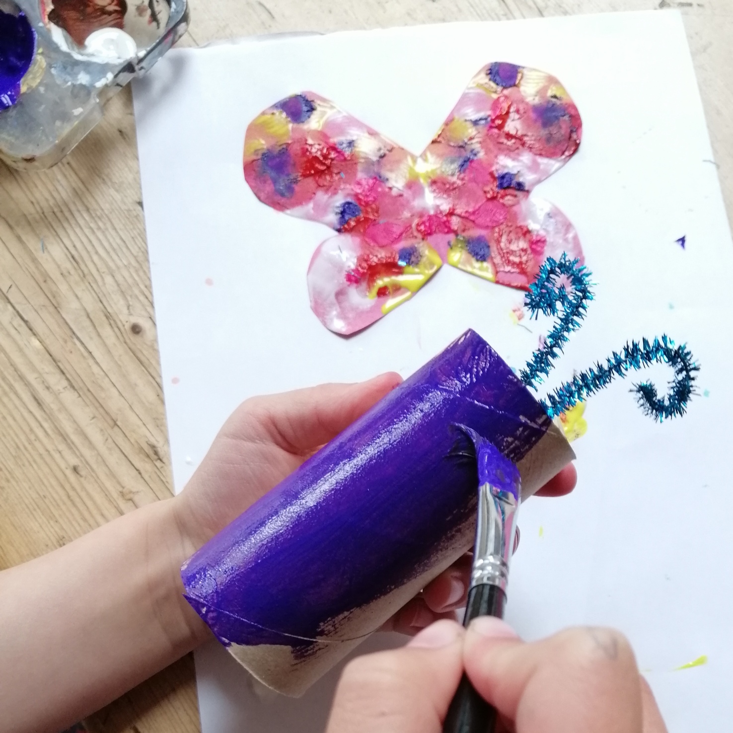 Painting a toilet roll for the butterfly's body