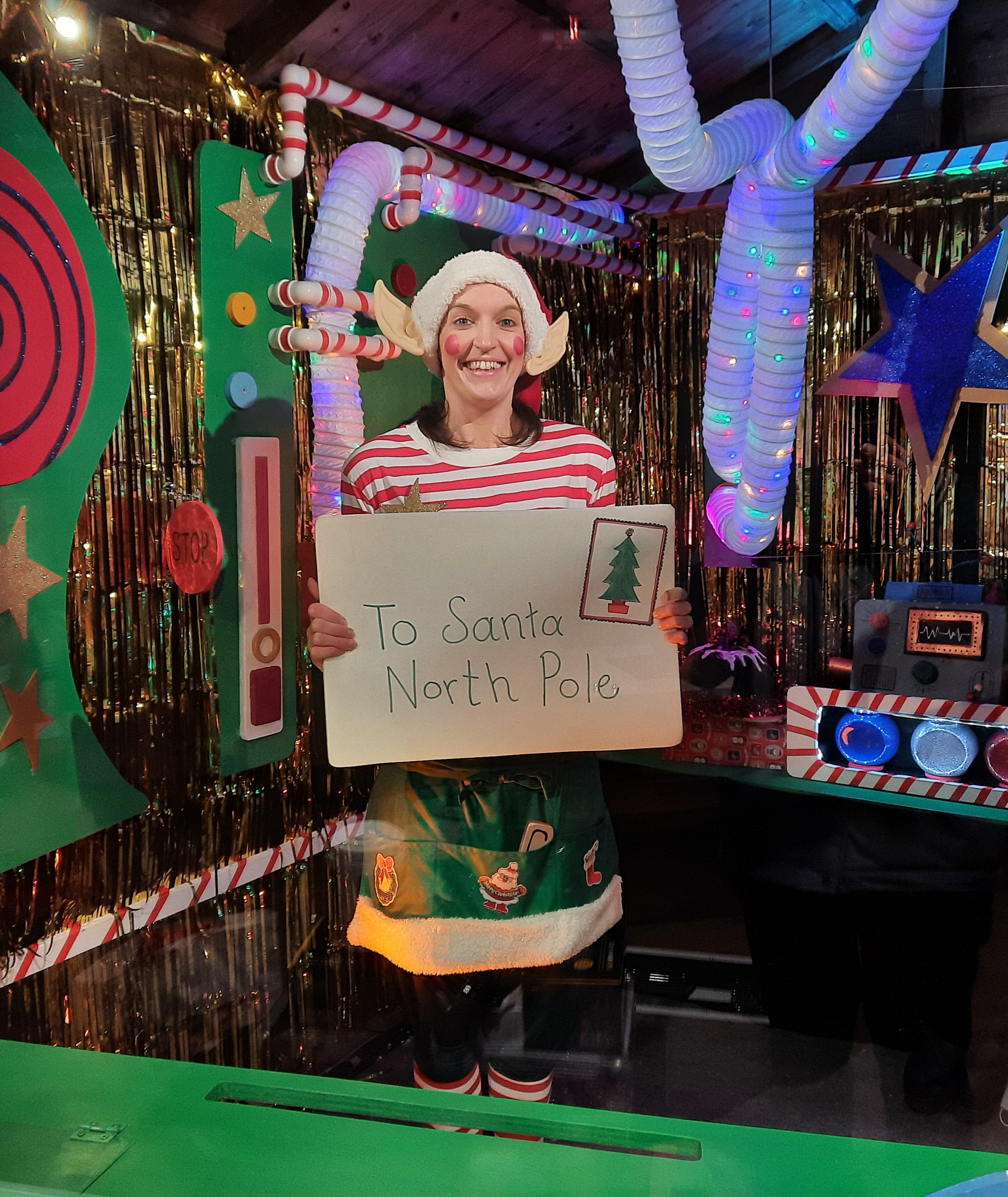 Bobby the elf holding a big letter addressed to santa