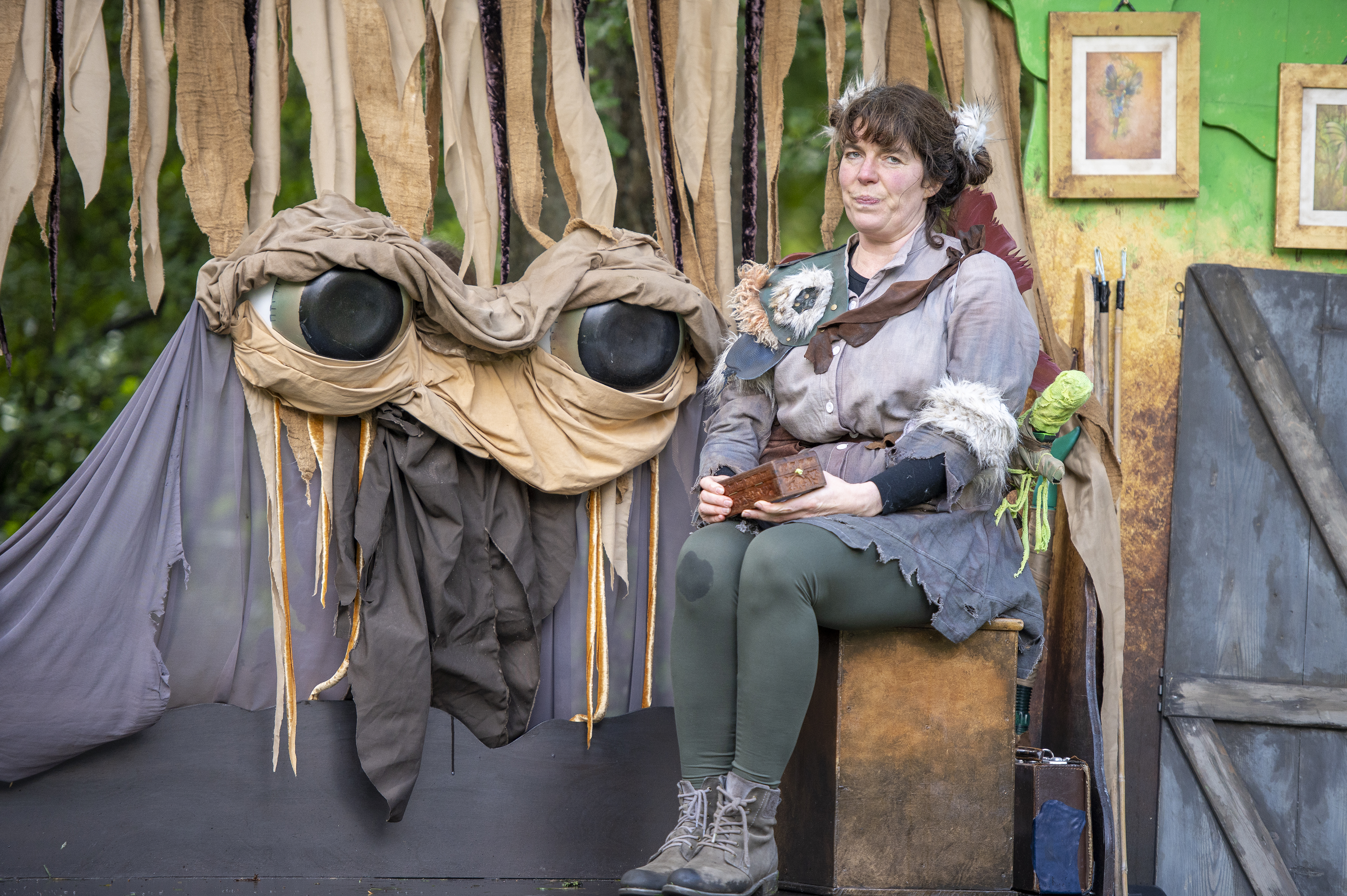 Bilberry the bog fairy sits next to a giant big eyed puppet called Peat