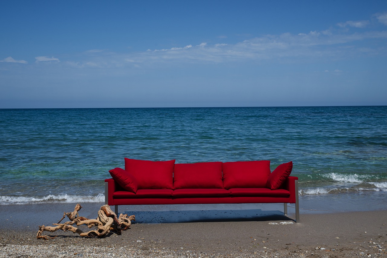 sofa on the beach in the waves