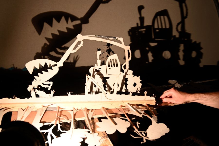a shadowy image of a truck. You can see the cardboard cut out and the shadow it produces on the screen