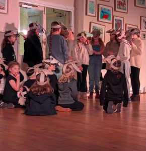 A youth Theratre production. All the young people are wearing masks they have made of either a wolf or a gost for their production of Wolves Versus Kids